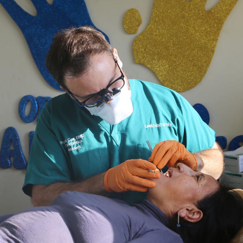 Dentist examining patient in Collique, Peru