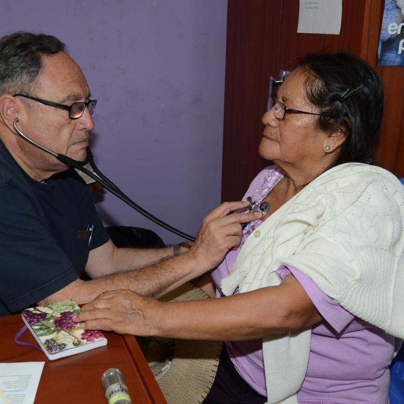 Luis Campos examines patient