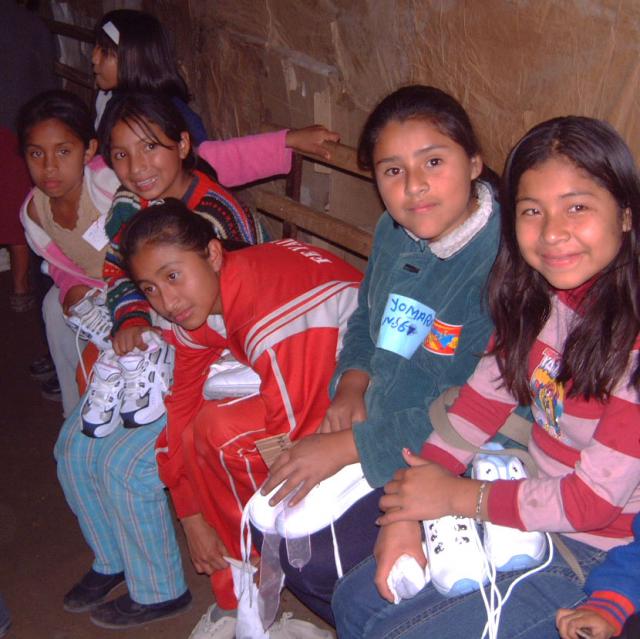 Children of Collique, Peru receiving new shoes