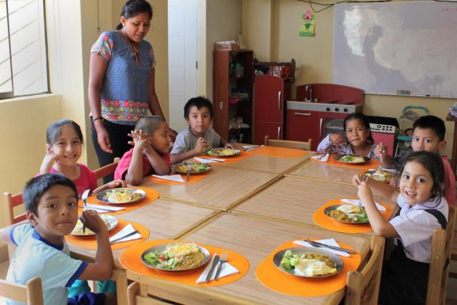 Students enjoy a nutritious meal at OSA House in Collique, Peru