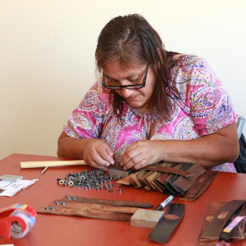 Woman making bracelets with Collique Cuffs