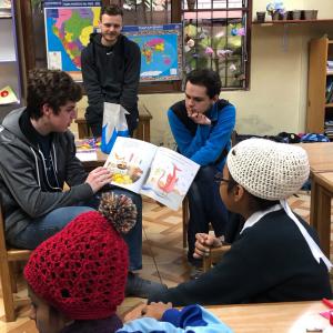 Mission Trip youth participants reading aloud with children